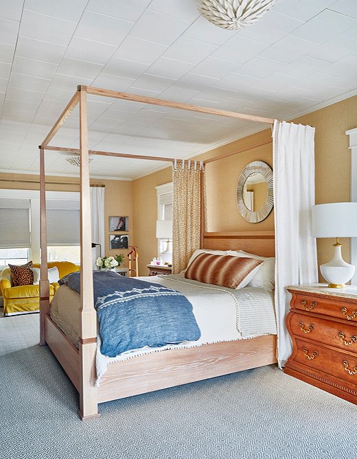 Along with window curtains and shades, this bedroom has a canopy bed with its own lined curtains for keeping out unwanted light. Room by Toledo Geller; photo by Jacob Snavely.
 
